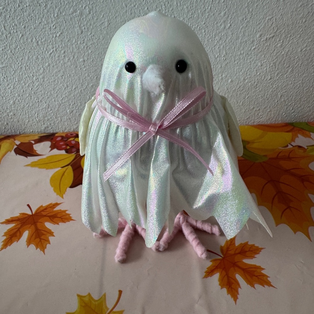 Featherly ghost dressed in a shimmer jagged hem gown with bow-tie detailing New.